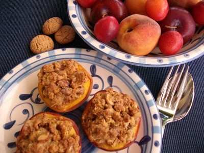 PESCHE ALLA PIEMONTESE Ingedienti per 4 persone: 4 pesche 40gr amaretti Alcune mandorle dolci pelate 4 cucchiai di zucchero 1 cucchiaio di cacao amaro in polvere 1 cucchiaio di burro 1 bicchiere di