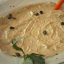 Add mayonnaise making a soft cream. Spread on the slices of veal arranged on a dish.