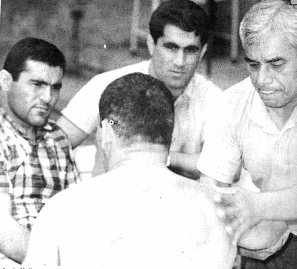 Fitness trainer Frank Medina giving a massage to his wrestler; Ahmet Ayık