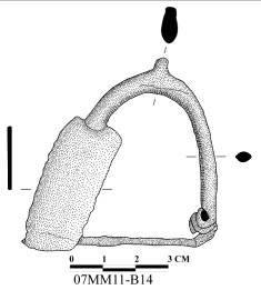 Katalog No: 58 Kazı Envanter No: 07MM11-B15 Eserin Adı: Fibula Ölçüleri: Uz: 3,6 cm, Gen: 3,7 cm, Kal: 0,7 0,1 cm Bulunduğu Tarih: 19.07.2007 Kazıda Bulunduğu Yer ve Tabaka: Güneydoğu köşeden 0,44 m, güneybatı köşeden 1,18 m uzaklıkta, mezar duvarı üst seviyesinden 0,94 m derinlikte bulundu.