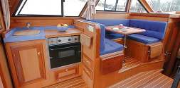 A large head with shower and teak bottom grill serves the whole boat.