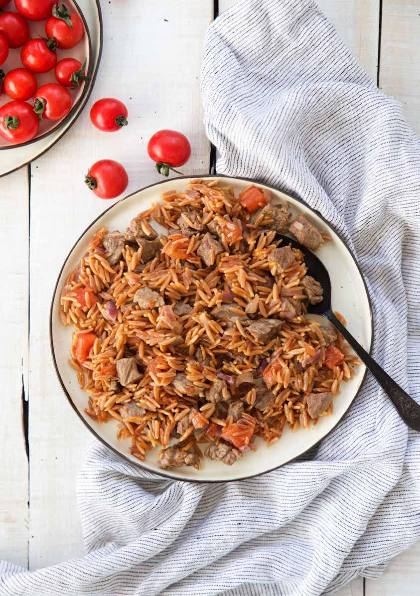 Continue to brown by adding the meat. Peel tomato and chop small. Add into the meat and brown for 1-2 minutes more. Add the water and cook. Melt the butter in another saucepan once the meat is cooked.